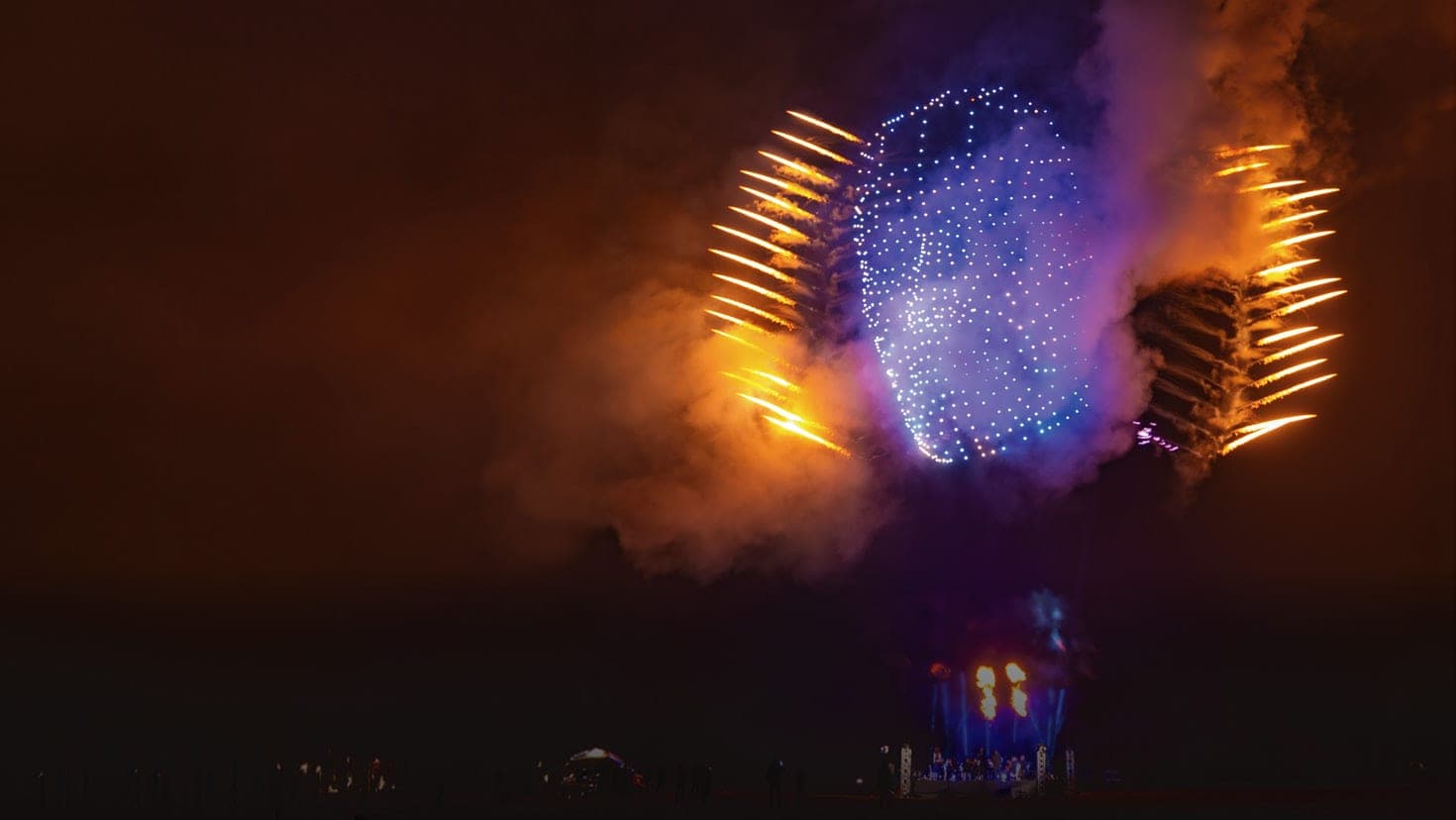 A FLYSTACK drone-and-pyrotechnic show finale lighting up the night sky
